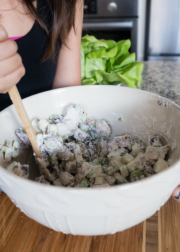 Stirring a bowl of Mayo Free Green Apple Chicken Salad.