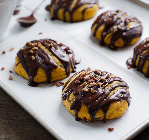 Pumpkin Cornmeal Scones drizzled with chocolate and topped with pecans.