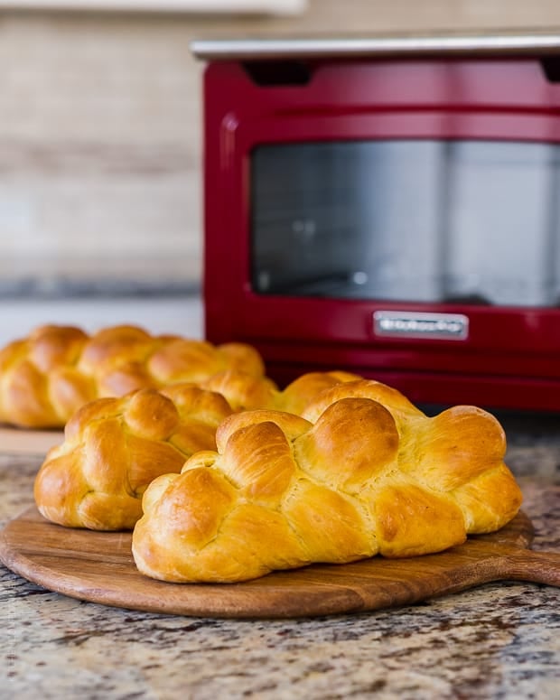 Loaves of Sweet Potato Challah on a counter top.