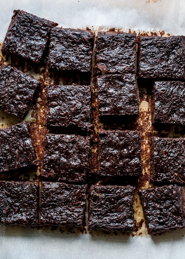 Slices of Zucchini Banana Brownies on parchment paper.