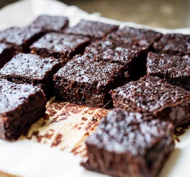 Zucchini Banana Brownies sliced on parchment paper.