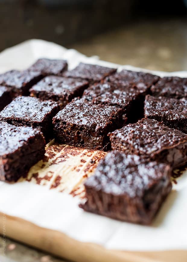 Zucchini Banana Brownies sliced on parchment paper.