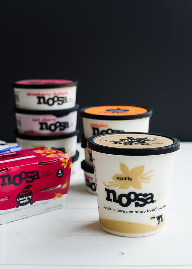 containers of noosa yogurt against a black background