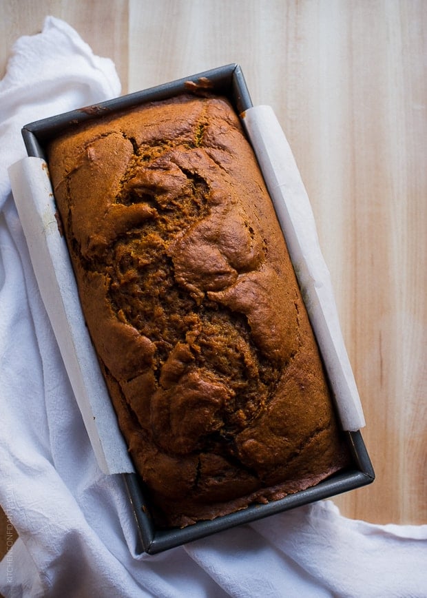 Chocolate Marble Pumpkin Bread in a loaf pan on a wooden counter top.