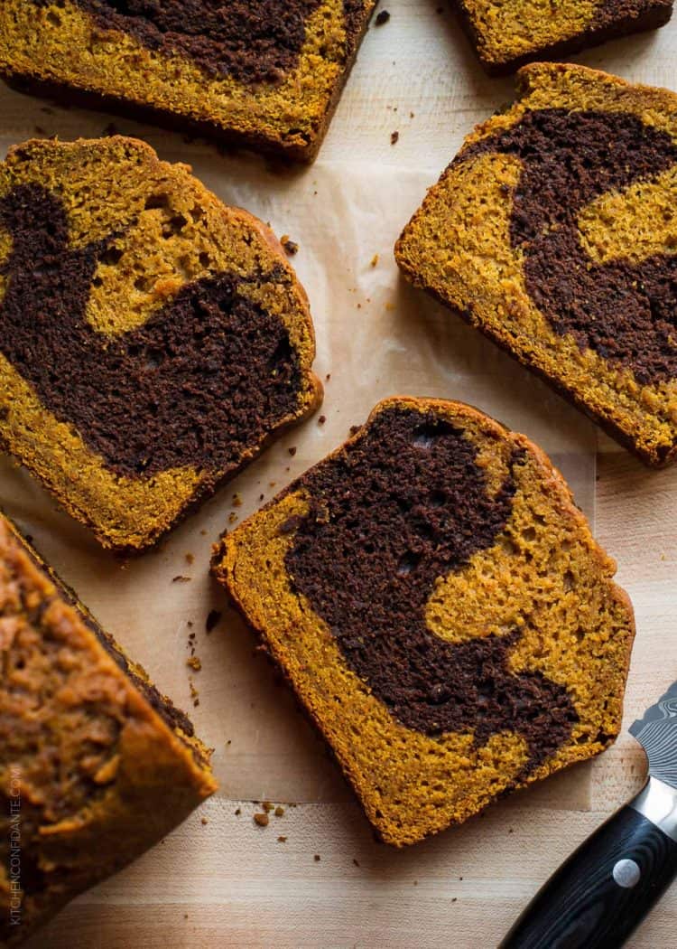 Slices of Chocolate Marble Pumpkin Bread on a cutting board.