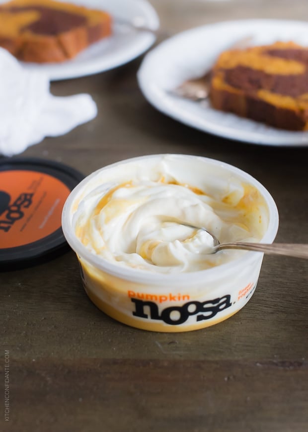 Open container of noosa pumpkin yoghurt with a spoon.