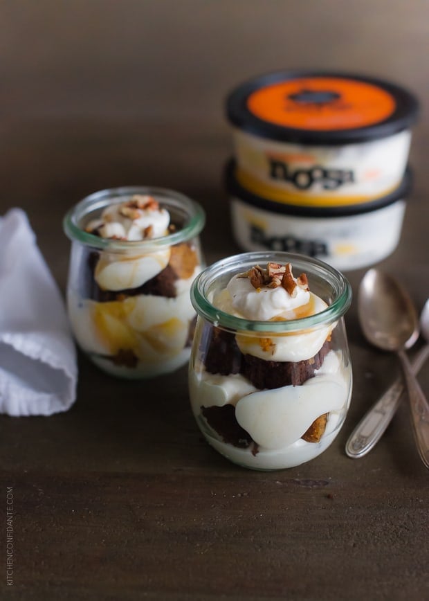 Pumpkin Bread Parfaits in glass jars with spoons alongside.