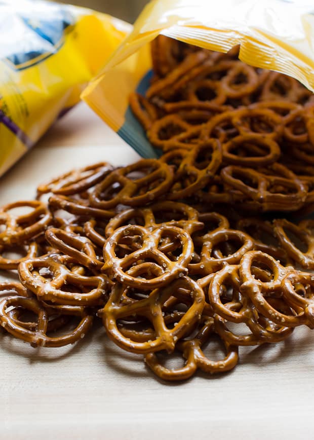 Pretzels spilling from an open bag onto a counter top surface.