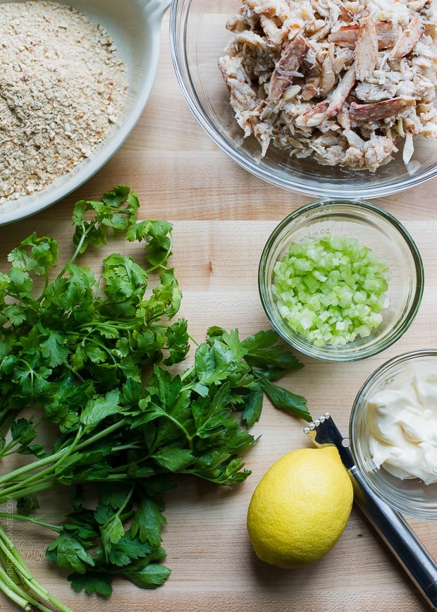 Ingredients to make crab cake sliders--crab meat, cilantro, parsley, and crushed pretzels.