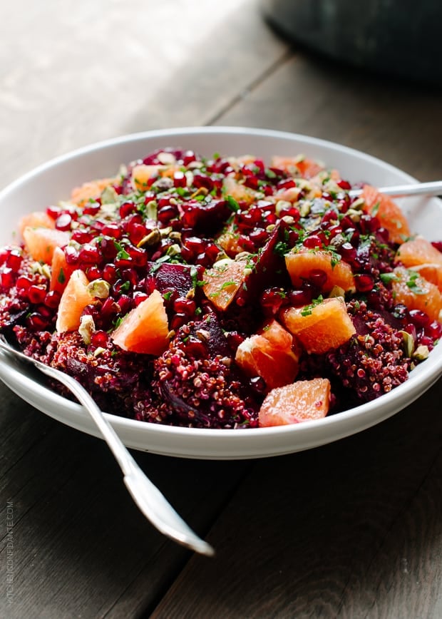 Quinoa Salad with Roasted Red Beets, Oranges and Pomegranate in a white bowl.