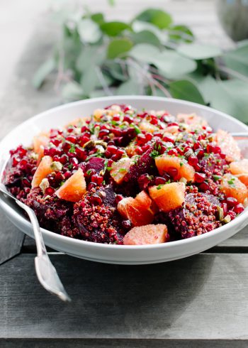 Quinoa Salad with Pomegranate Arils in a white salad bowl.