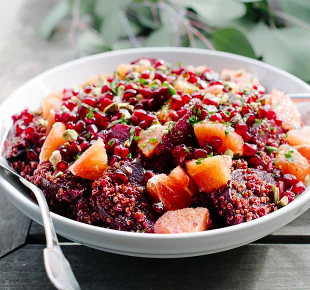 Quinoa Salad with Pomegranate Arils in a white salad bowl.