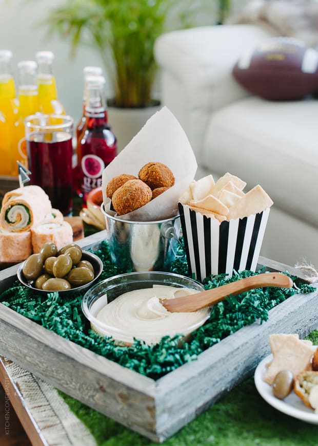 Roasted Eggplant Falafel Bites served with hummus and other game day appetizers.