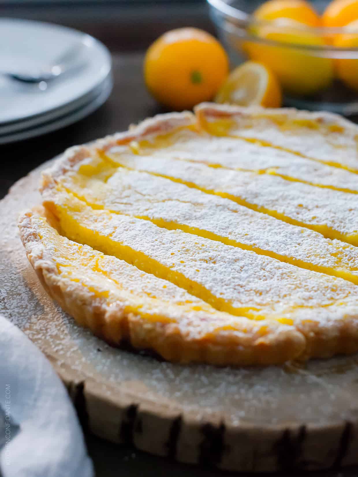 A Meyer Lemon Tart sliced on a serving platter.