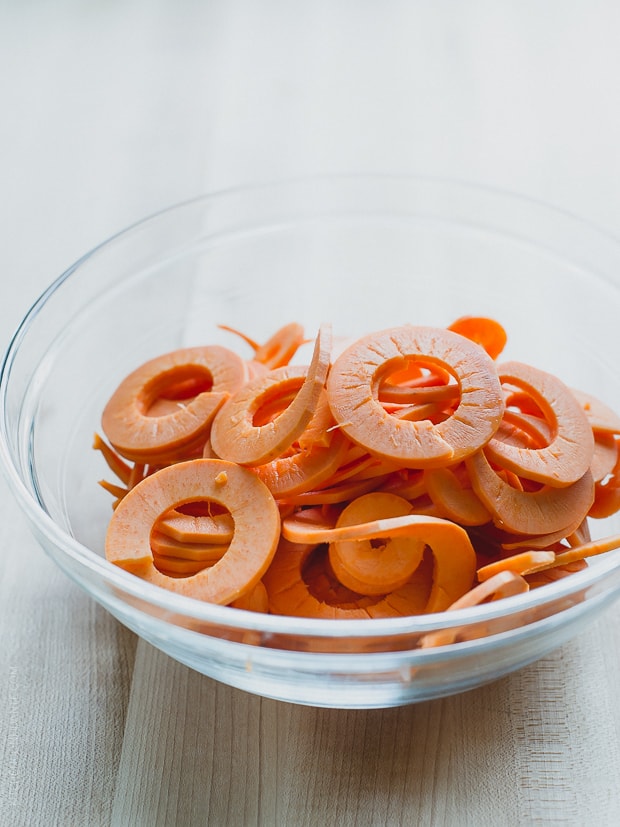 Spiralized sweet potatoes in a glass bowl.