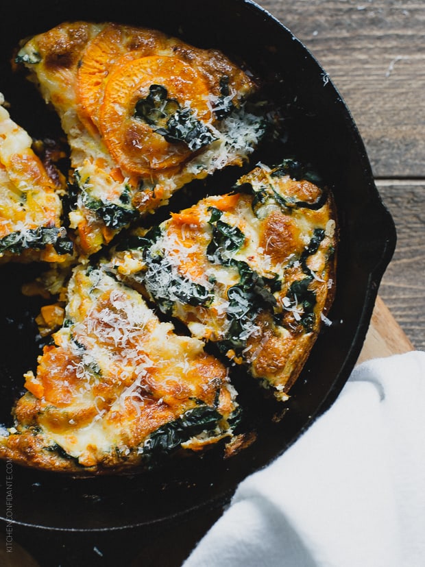 A sliced frittata in a cast iron skillet.