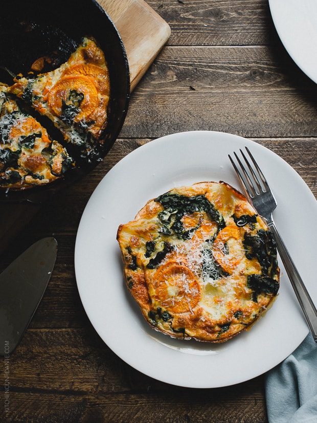 Spiralized Sweet Potato Kale Egg White Frittata on a white plate with a fork.