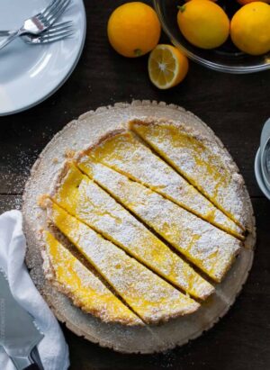 A Meyer Lemon Tart sliced on a serving platter.