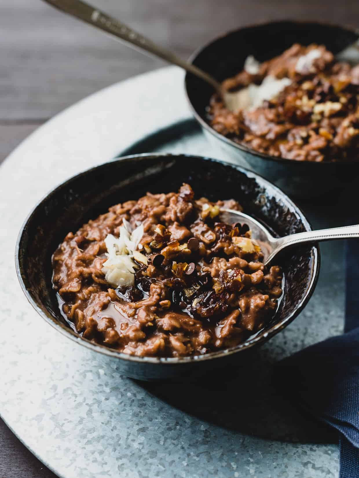 A bowl of Chocolate Porridge topped with mini chocolate chips.