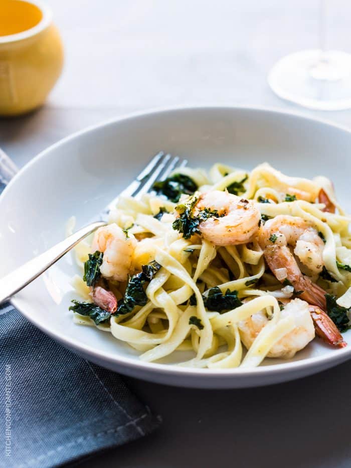 Freshly cooked linguine, leafy kale, and shrimp twirl together on a dinner plate to create Kale and Shrimp Scampi.