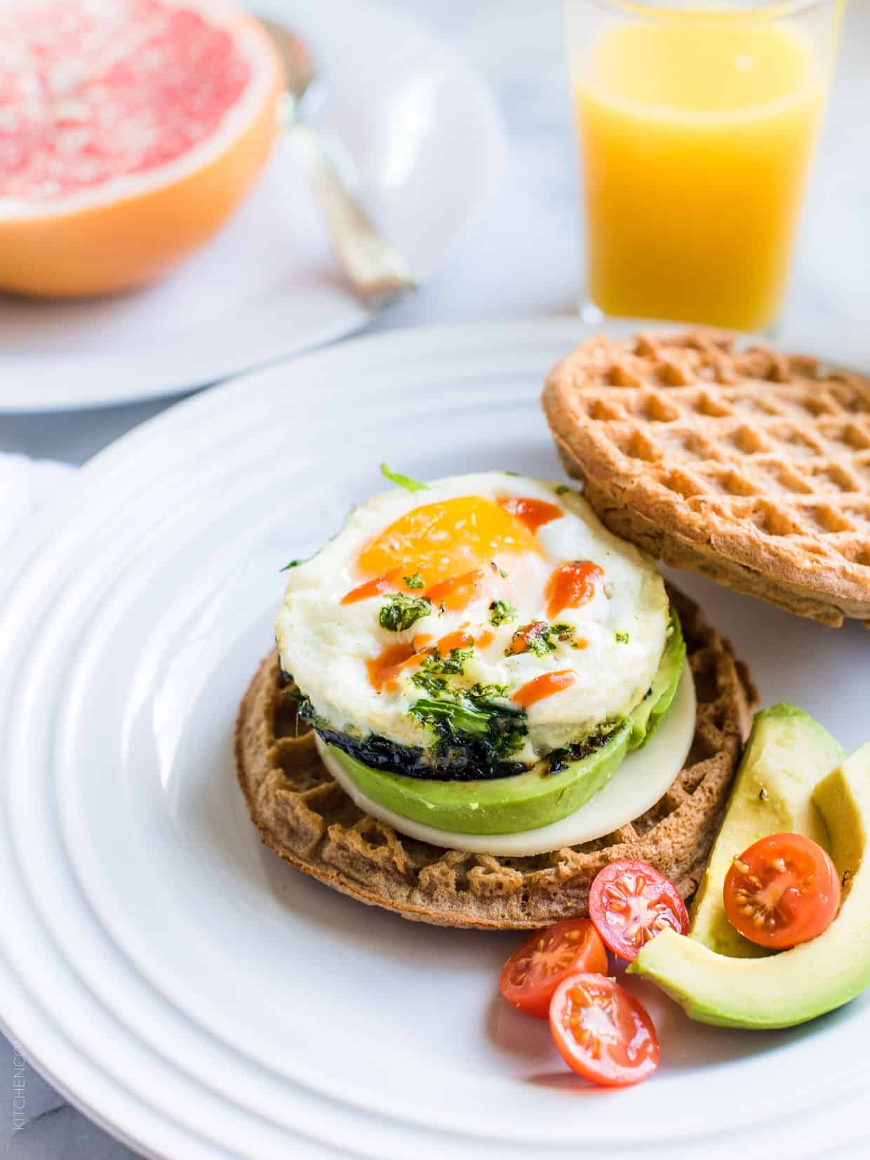 A Waffle Breakfast Sandwich filled with a microwaved egg, avocado, and hot sauce.