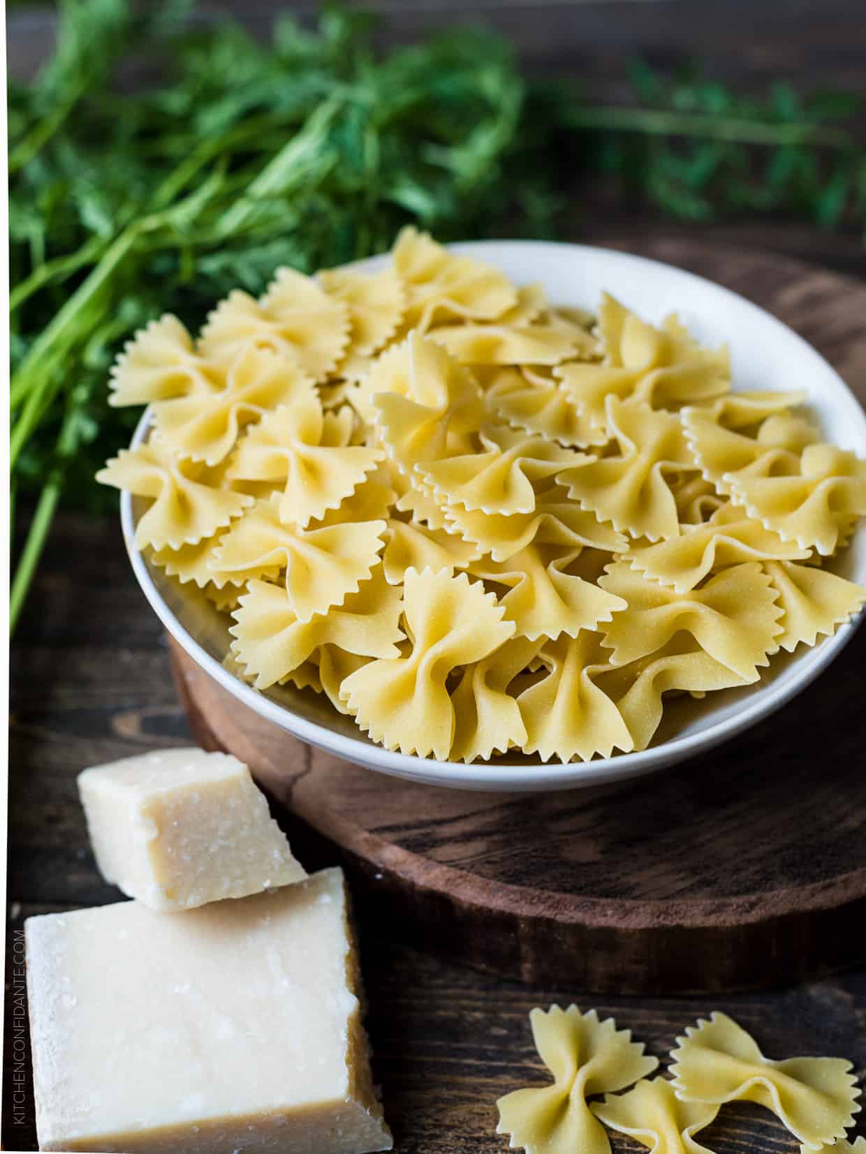 A bowl of dried farfalle pasta.