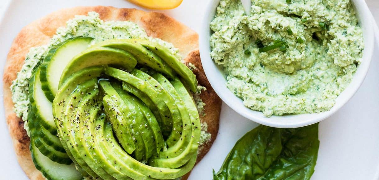 A toasted naan topped with Green Goddess feta spread and an avocado rose.