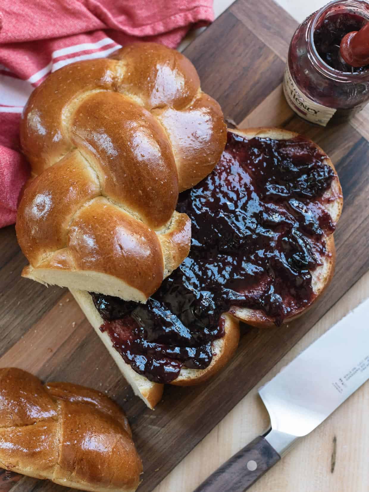 Leftover brioche bread spread with strawberry jam to use in a Rhubarb Bread Pudding.