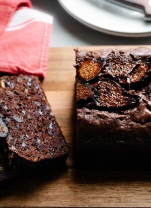Sliced loaf of Chocolate Banana Fig Bread with slices of fig on top.