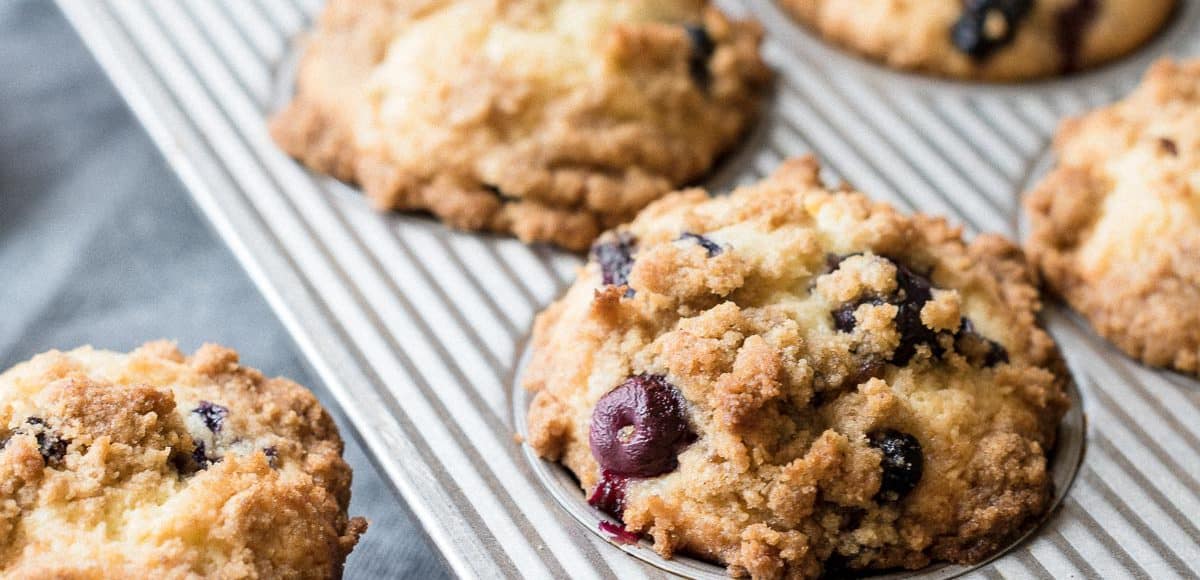 Bakery Style Buttermilk Blueberry Muffins in a muffin tin.