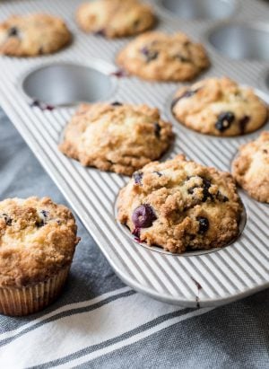 Bakery Style Buttermilk Blueberry Muffins in a muffin tin.