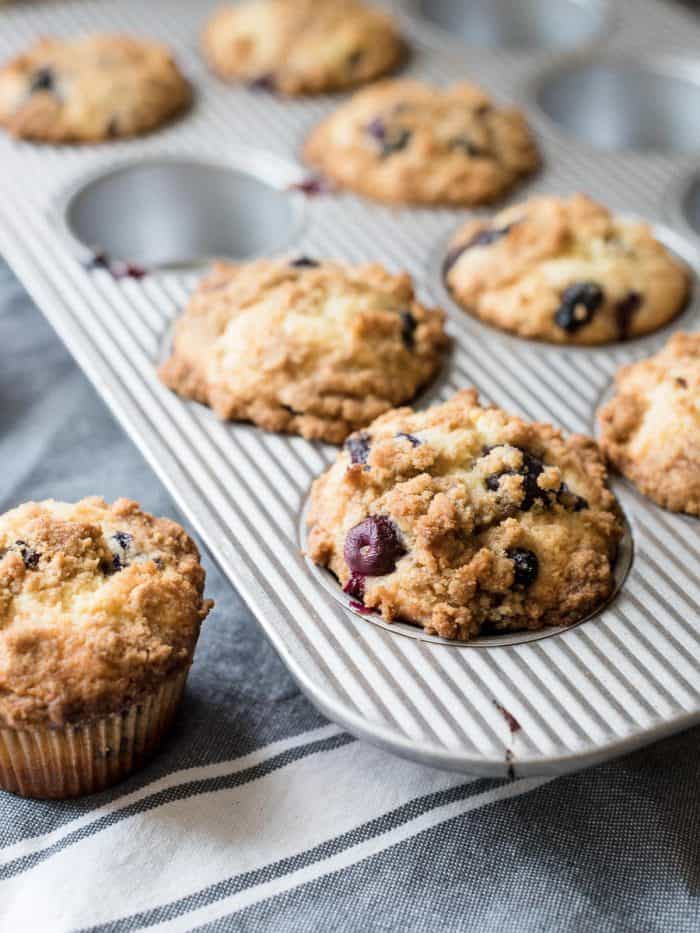 Bakery Style Buttermilk Blueberry Muffins in a muffin tin.
