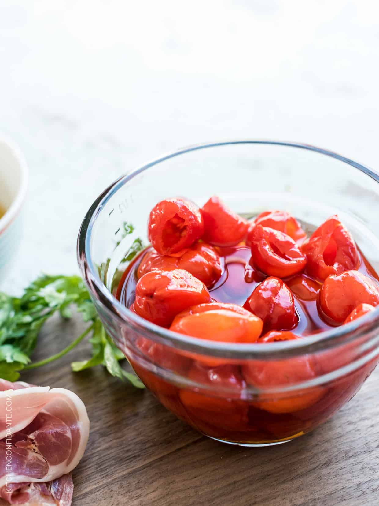 A glass bowl filled with peppadew peppers.