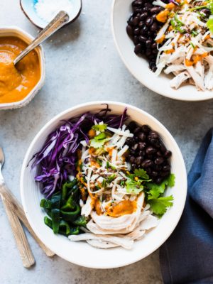 Salad prepared with shredded chicken, cabbage, black beans, charred poblanos, and pumpkin-red curry vinaigrette.