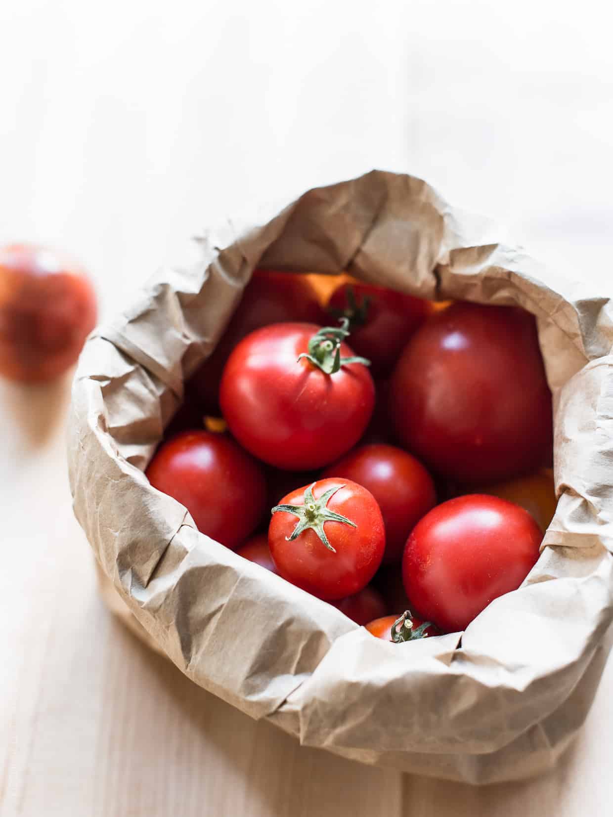 Fresh Heirloom Tomatoes in a paper sack.