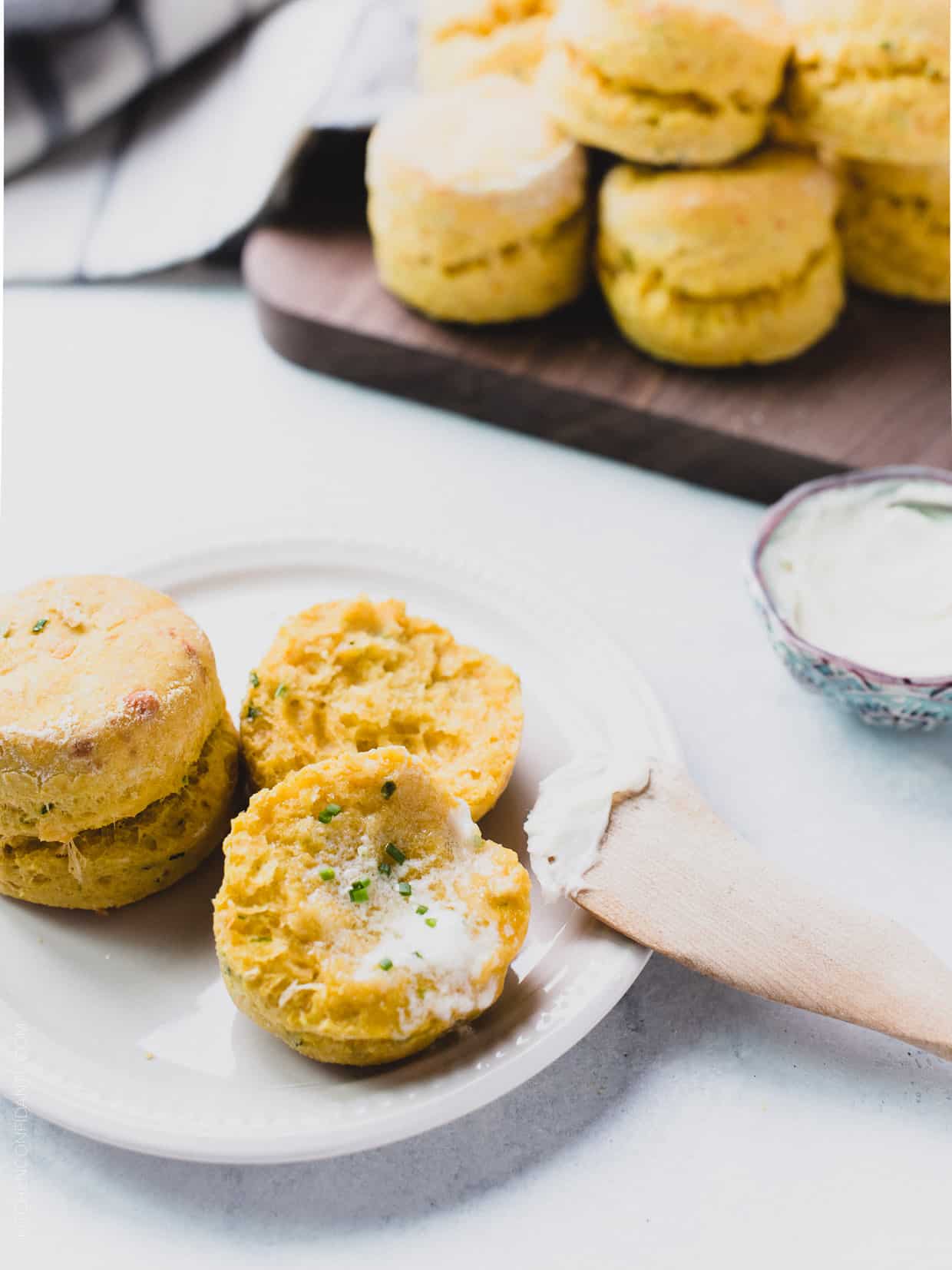 Fresh from the oven Pumpkin Cheddar Biscuits gently broken open and served with butter.