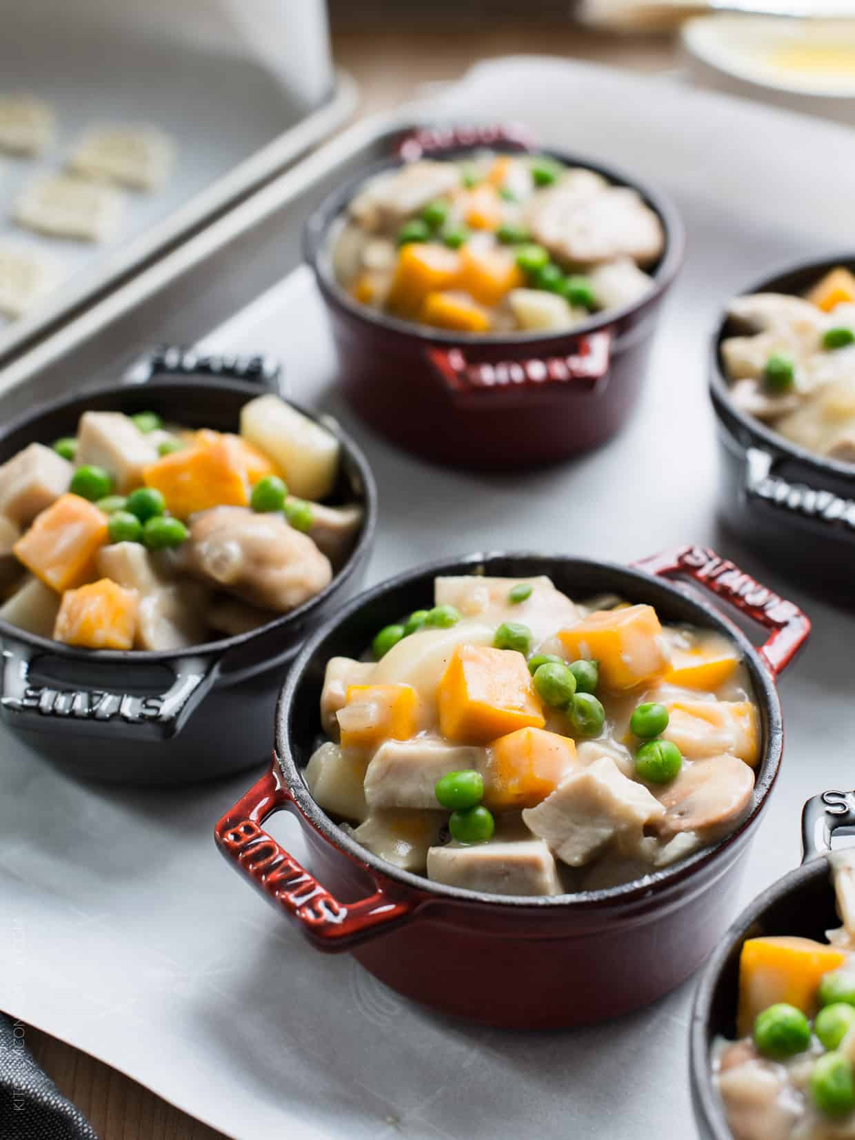 Turkey Pumpkin Pot Pie filling in individual ramekins ready to be topped with crust and baked.