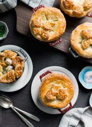 Turkey Pumpkin Pot Pies baked in single serving Dutch ovens and topped with a golden-brown puff pastry crust.