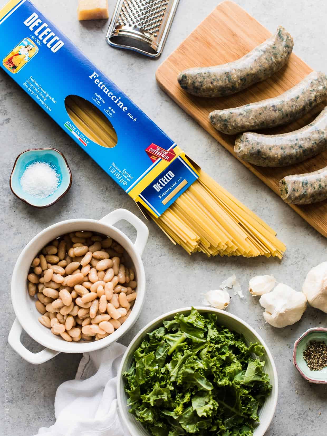 Ingredients assembled to prepare Fettuccine with Chicken Sausage, Kale and Cannellini Beans.