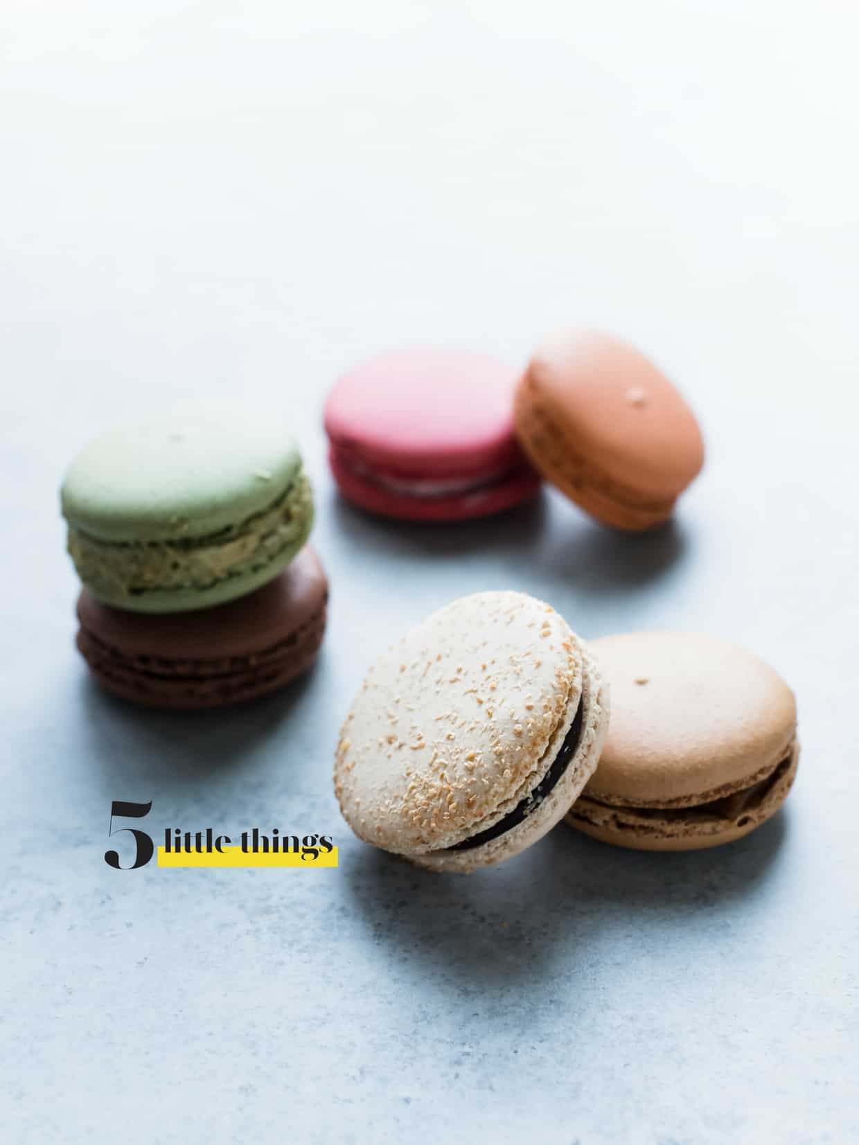 Selection of macaron cookies arranged on a counter top.