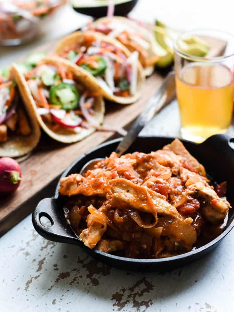 Chipotle chicken for tacos in a black dish.