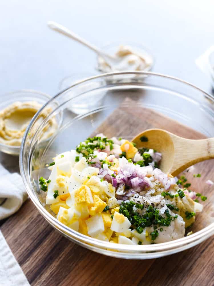 Chopped ingredients for Hummus Egg Salad in a bowl.