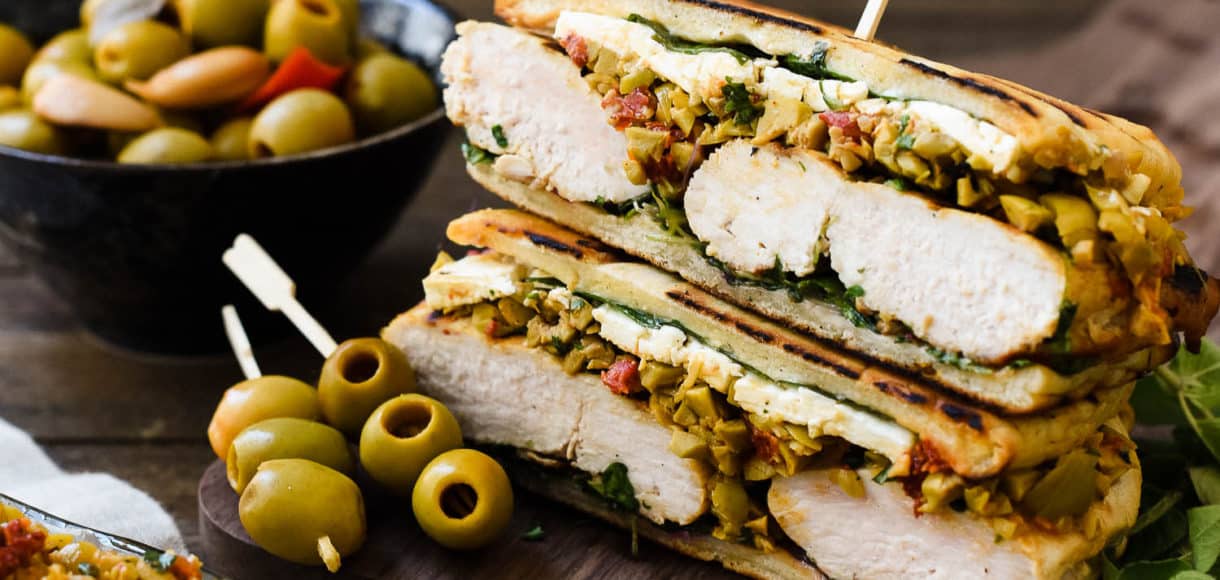 Olive-brined Chicken Sandwich with Olive Tapenade gets its incredible flavor from chicken brined in a Spanish blend olive brine, savory feta cheese, and a hearty spread of olive tapenade. This post is sponsored by Lindsay olives.