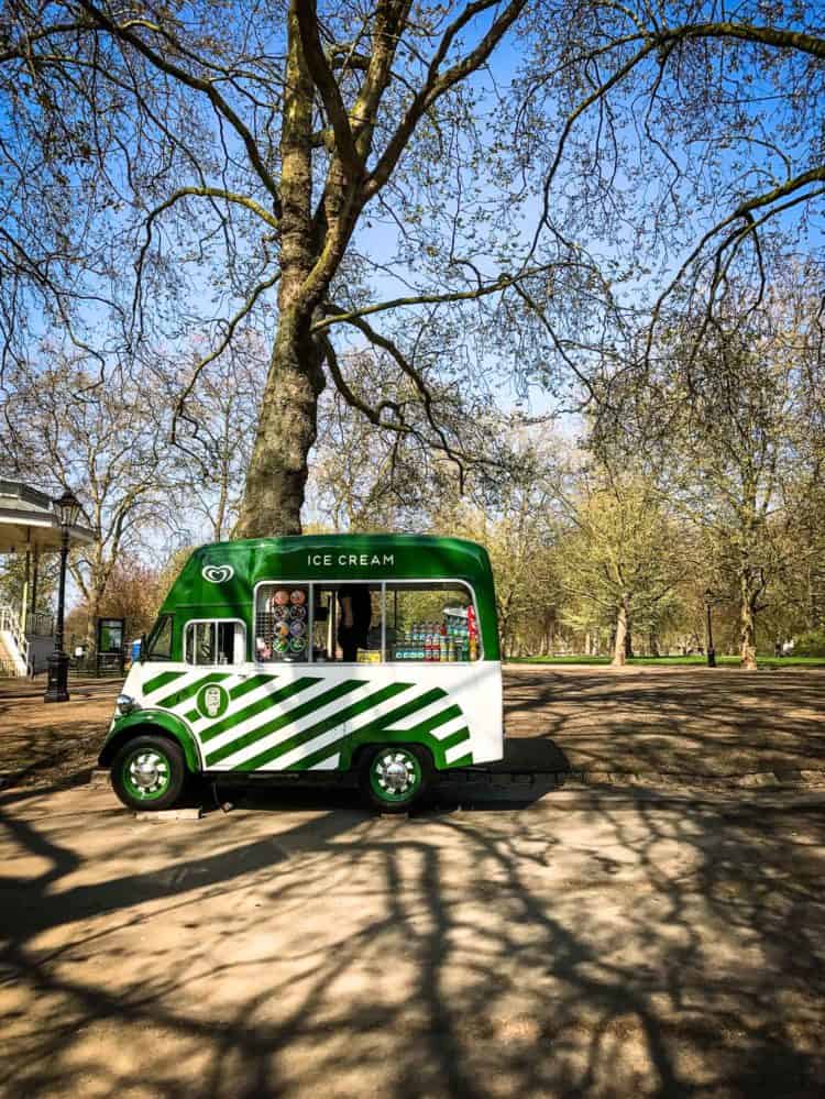 Green and white striped ice cream truck in Hyde Park, London.