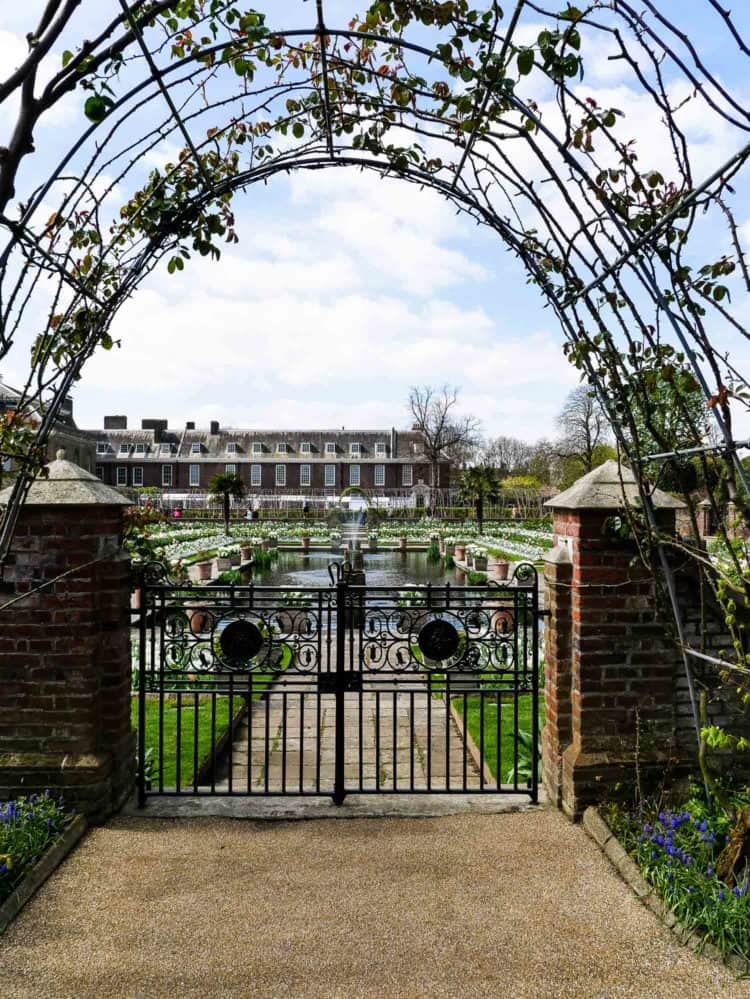 A wrought iron gate and arch in Kensington Palace garden.