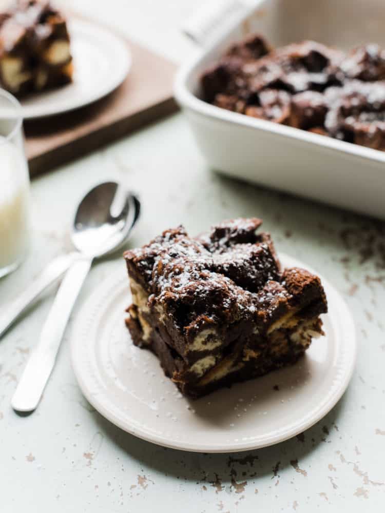 Chocolate bread pudding serving on a white plate.