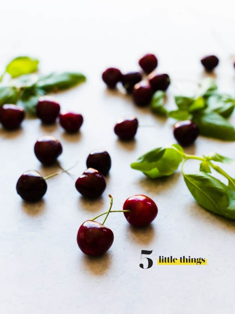 Fresh cherries spread out on a countertop.