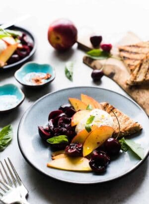 Summer stone fruit, fresh basil, and creamy burrata dressed in a zingy balsamic vinegar and olive oil is the perfect summer appetizer! I used nectarines and cherries, but this will work for any stone fruit you like – try it with plums, peaches, and apricots, too!