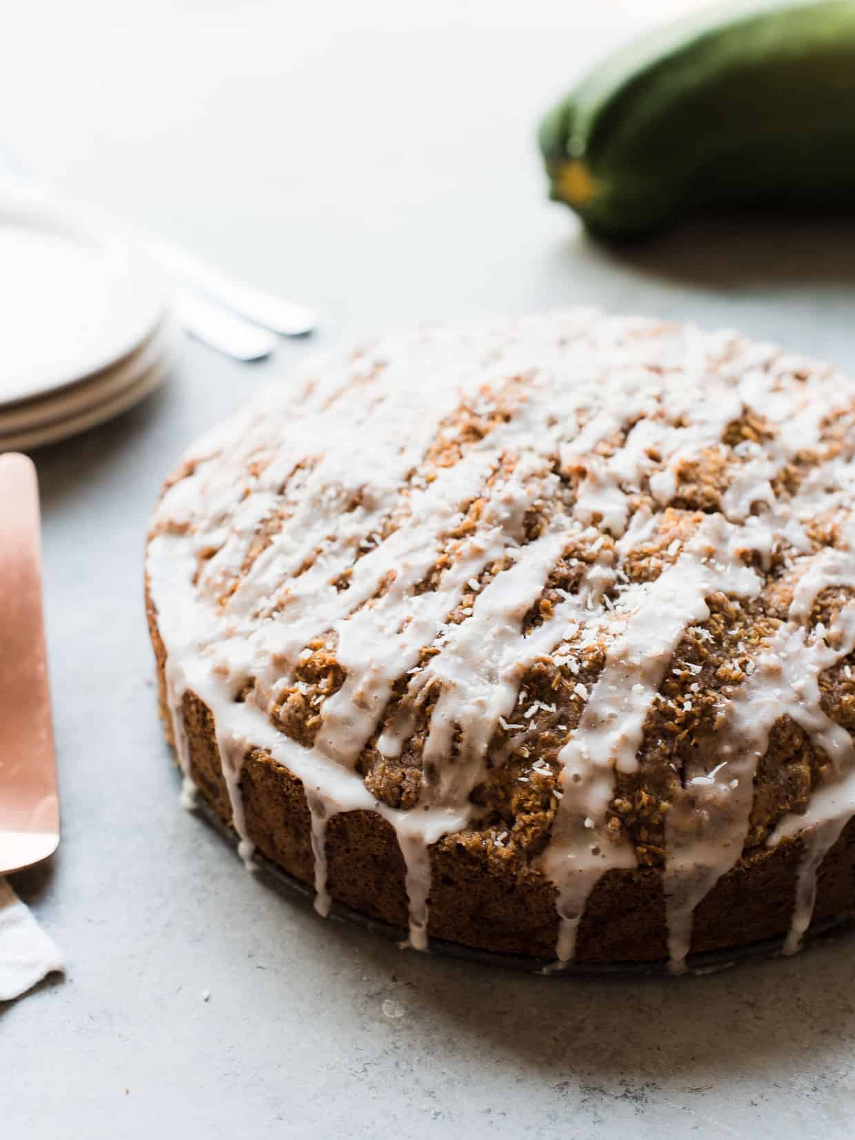 Coconut zucchini coffee cake on a grey background.