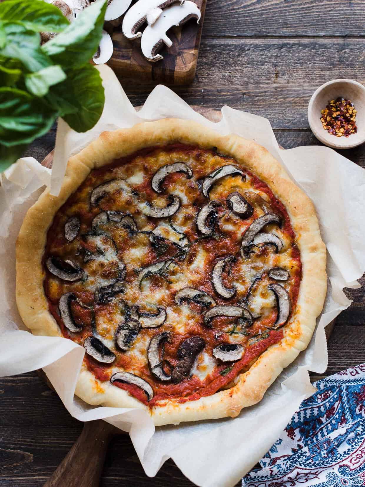 Freshly baked Dutch Oven Pizza on a wooden surface.